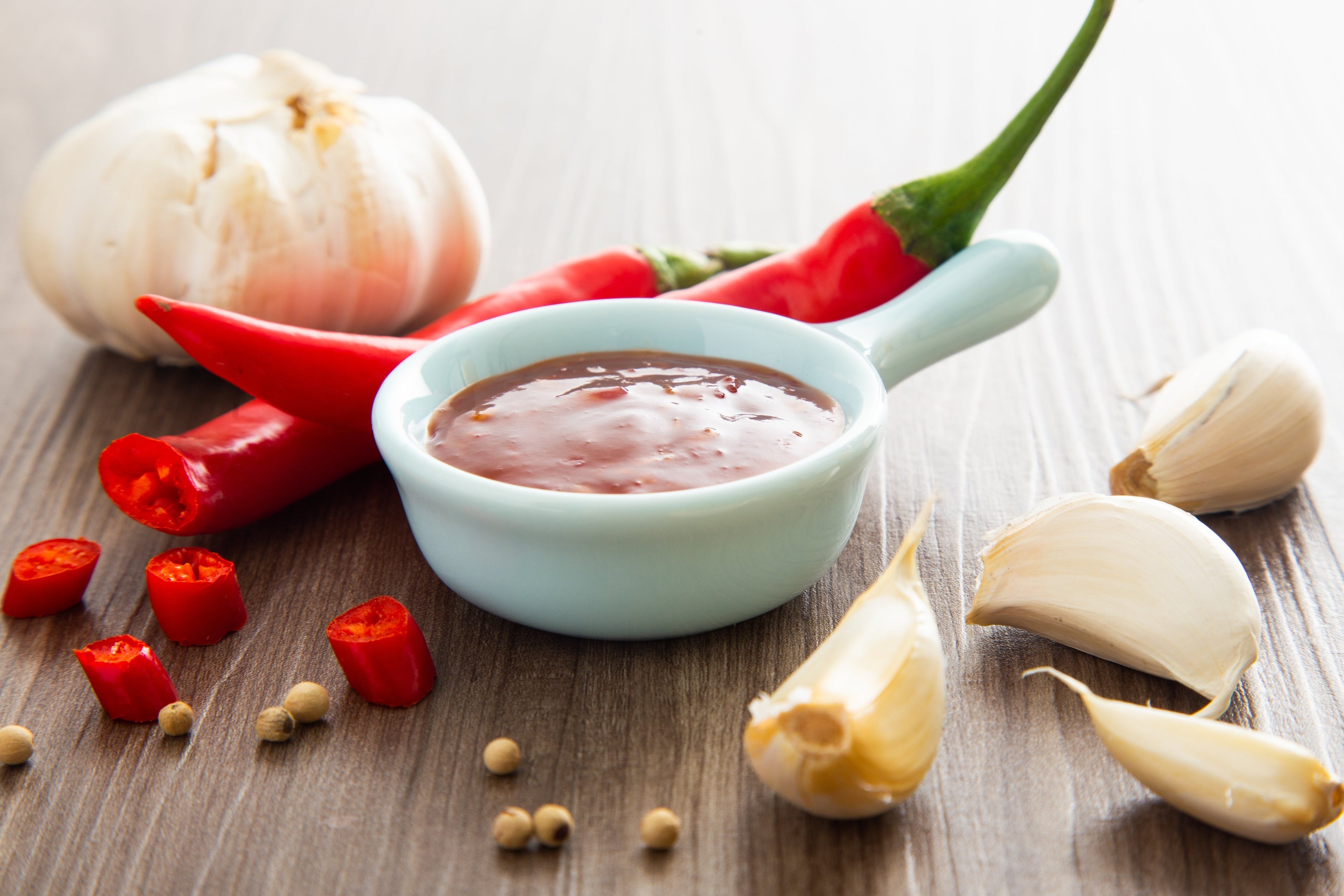 Bowl of hot chili sauce with red peppers