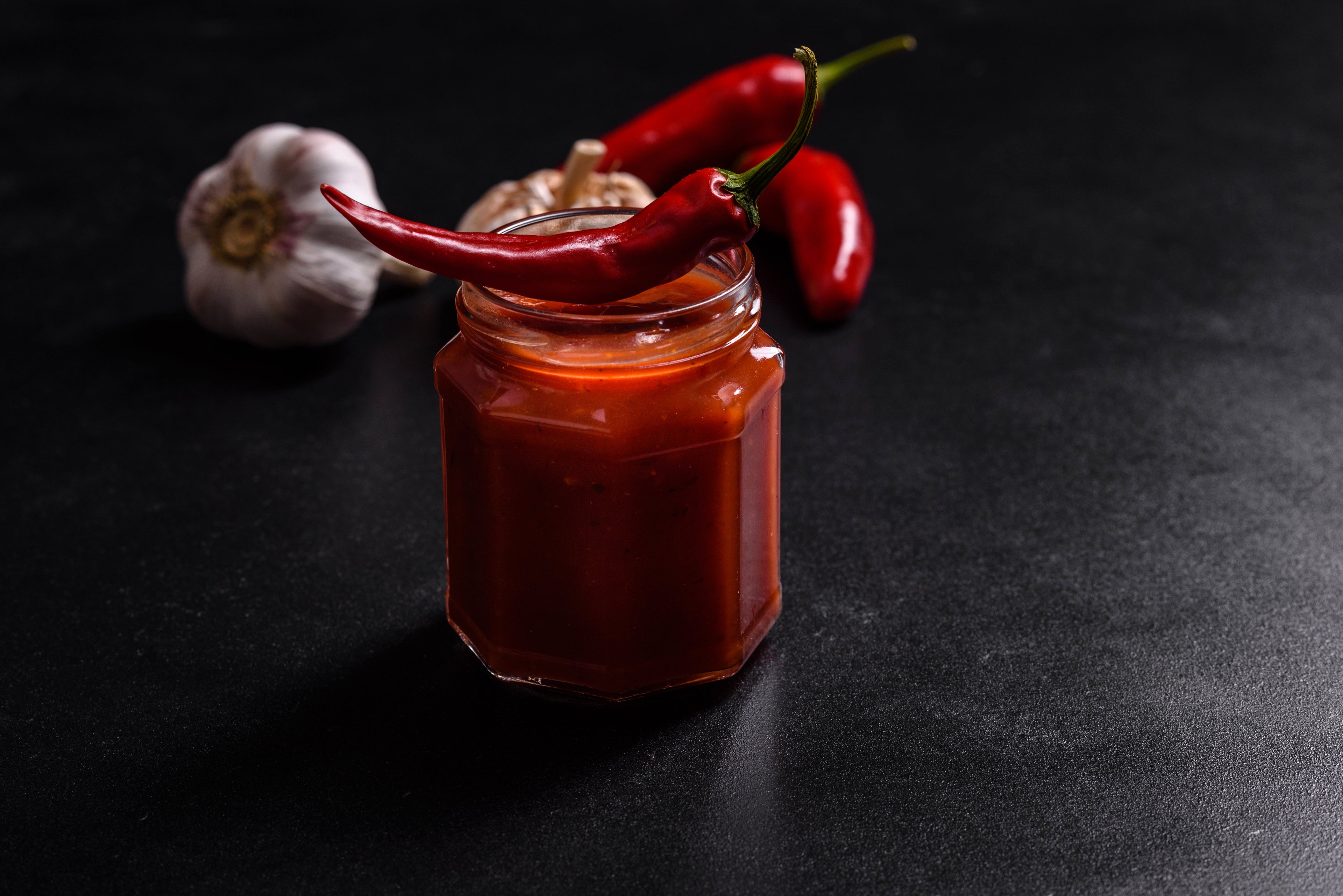 Glass jar with homemade spicy tomato pasta sauce